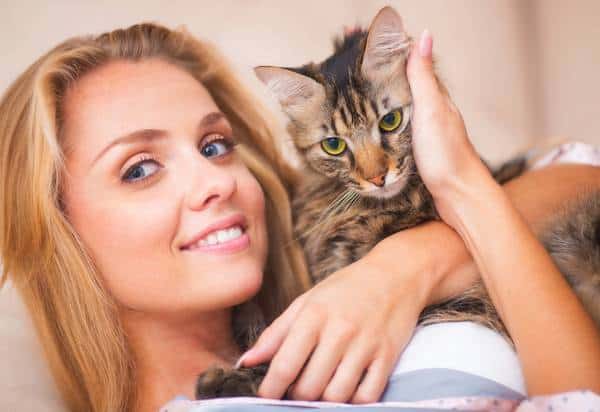 Beautiful woman hugging a cat